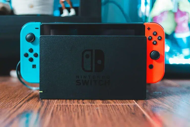 A nintendo switch docked with the red and blue joycons