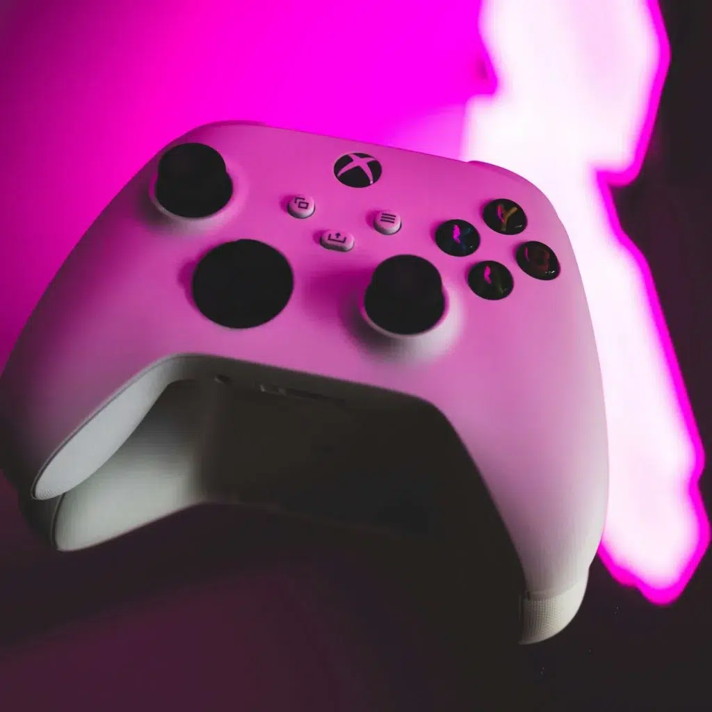 Xbox controller with a pink glowing light on it